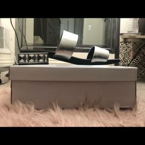 Silver flat sandals with a mirror glass look sole